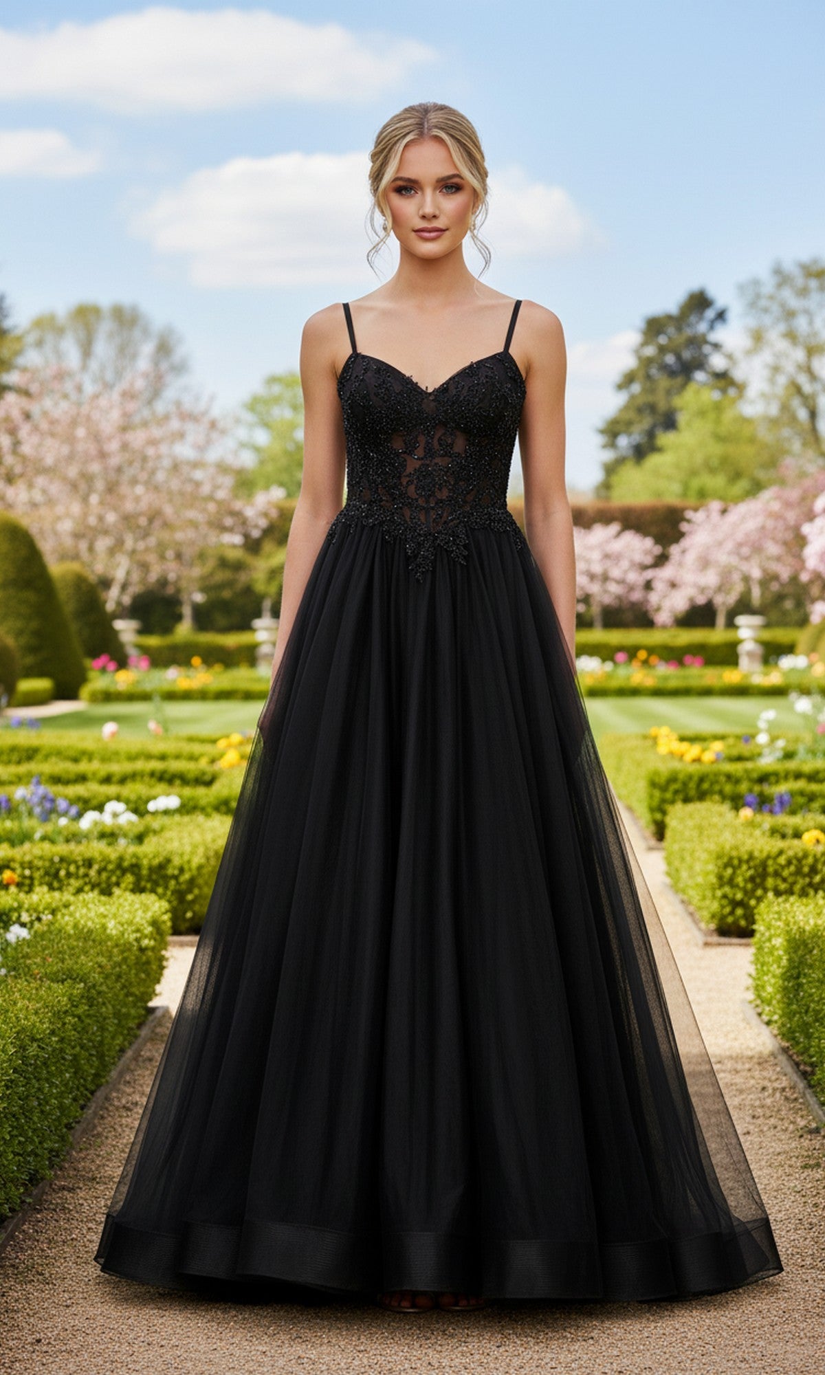 Outdoors in a formal garden, a woman wears the Long Prom Dress: La Femme 33436—a black, floor-length A-line gown with a high slit, fitted lace bodice, and thin straps.
